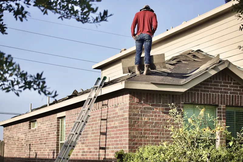 Professional roofer working on a residential roof in Stratfield